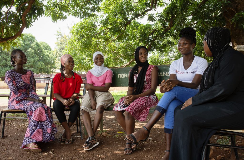 Belawu sits with her sisters in the CAMFED Association