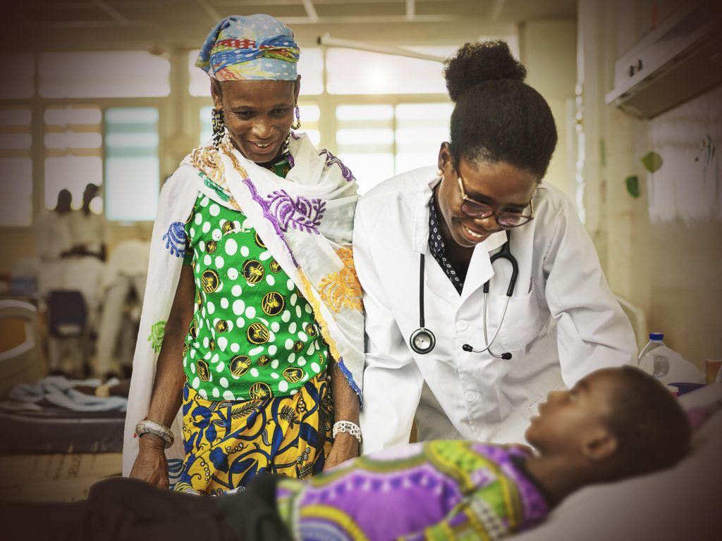 Bertha, a medical doctor in the CAMFED Association in Ghana, pictured with a patient at Tamale Teaching Hospital
