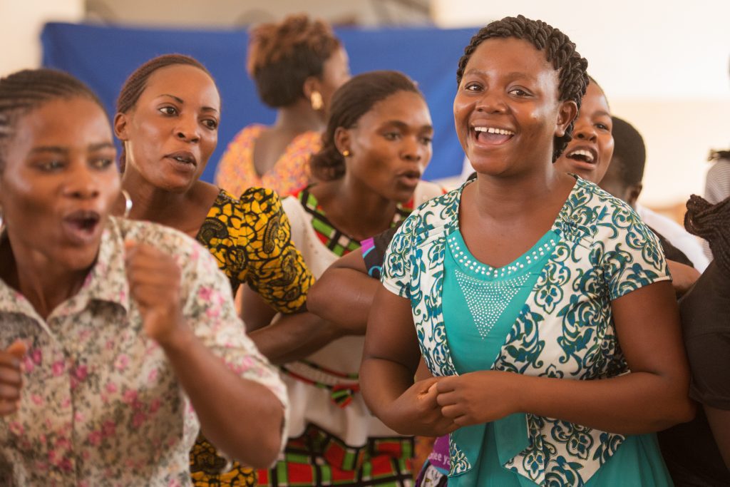 Stumai dances with her sisters in the CAMFED Assocition