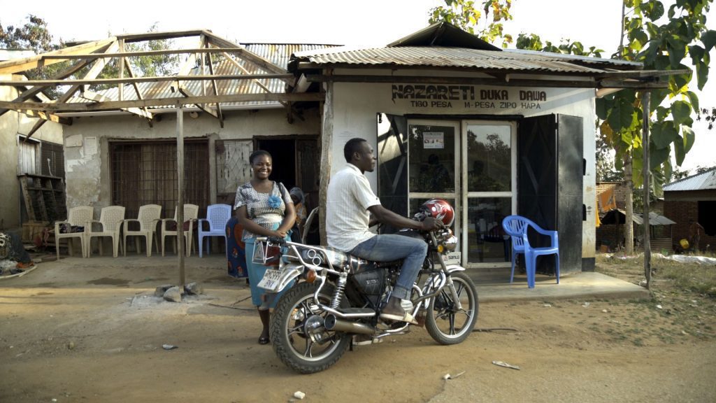 Stumai outside her motorcycle business in Tanzania
