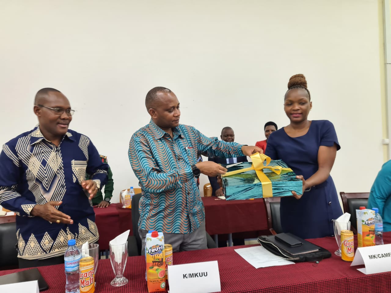 Laptop handover, Ms Nasikiwa Duke (National Director CAMFED TZ) and Prof. Abel Makubi PS MoH, Nov 2022