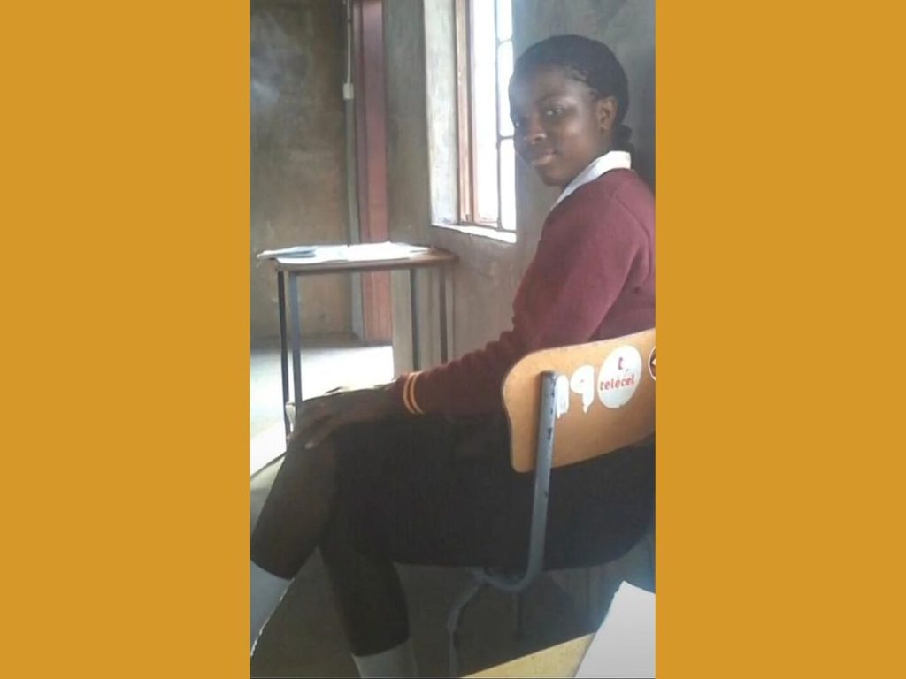 Yvonne from Zimbabwe pictured at her desk in the classroom, during her time in school.