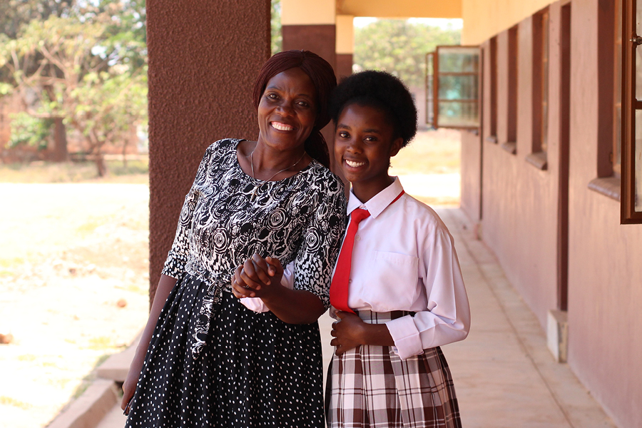 A female Zambian Teacher and her student.