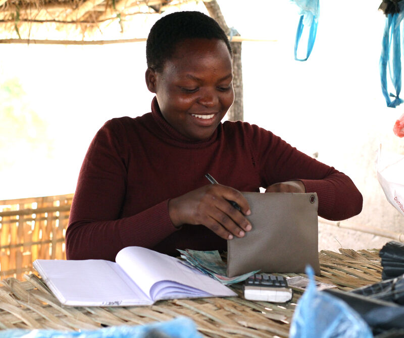 Christina, a young Malawian woman in her shop.