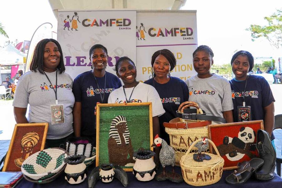 Six young Zambian women artists showcase their crafts and smile.