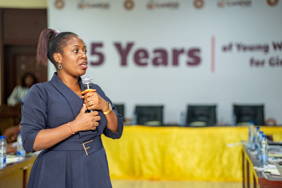 Diris, a Tanzanian woman speaks into a microphone